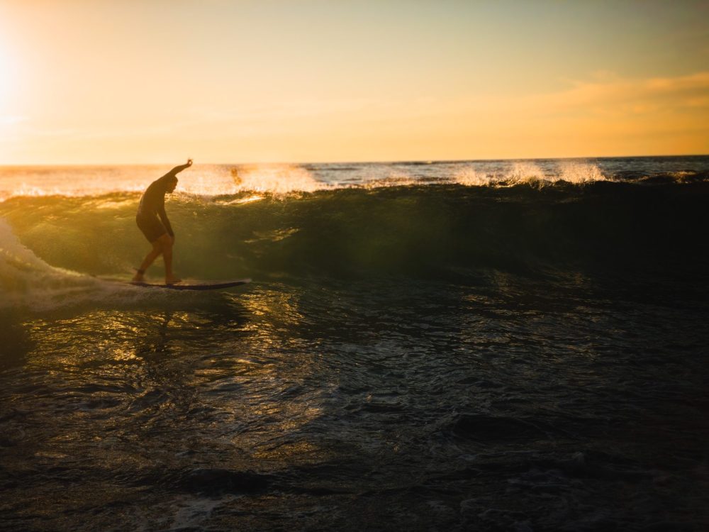 a man riding a wave on a surfboard in the ocean