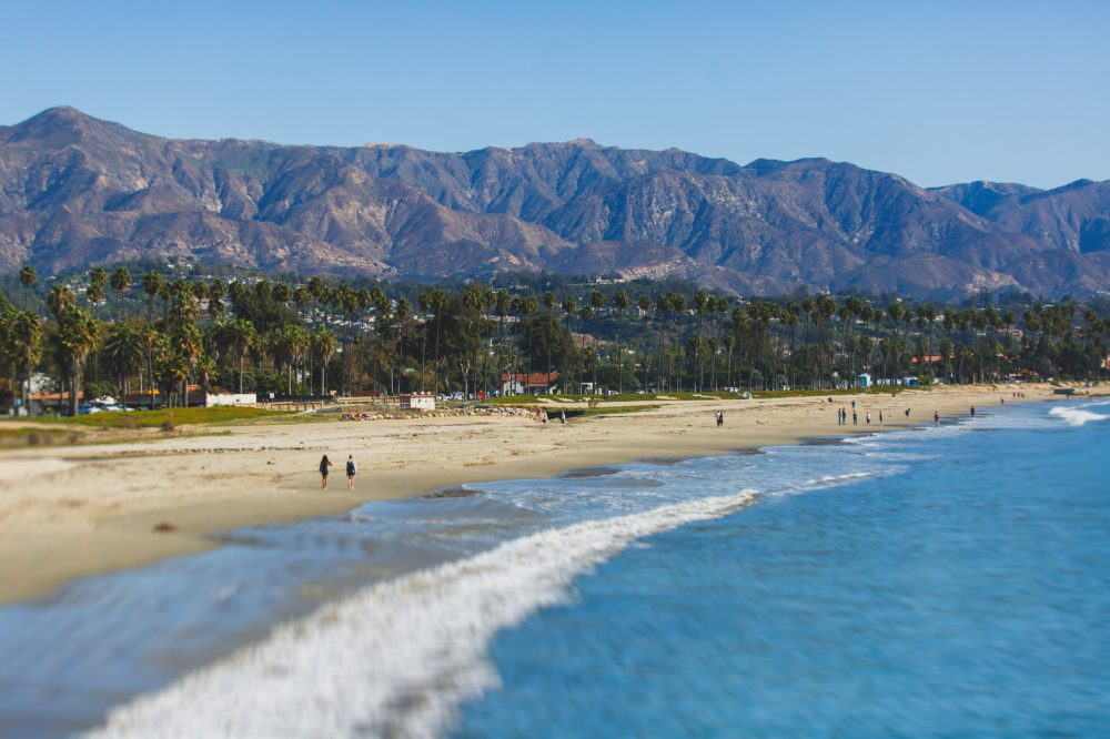 Beautiful view of Santa Barbara ocean front walk, with beach and marina, palms and mountains, Santa Ynez mountains and Pacific Ocean, Santa Barbara county, California, United States, summer sunny day